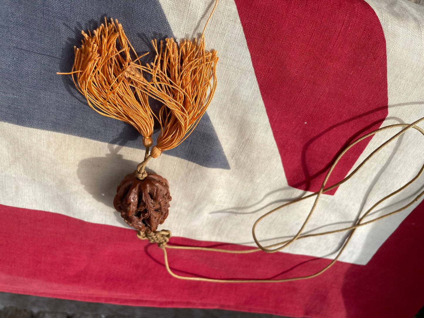 A Hand Carved Chinese Peach Stone Carving on a Silk Cord and Everlasting knot Tassel 42mm Long