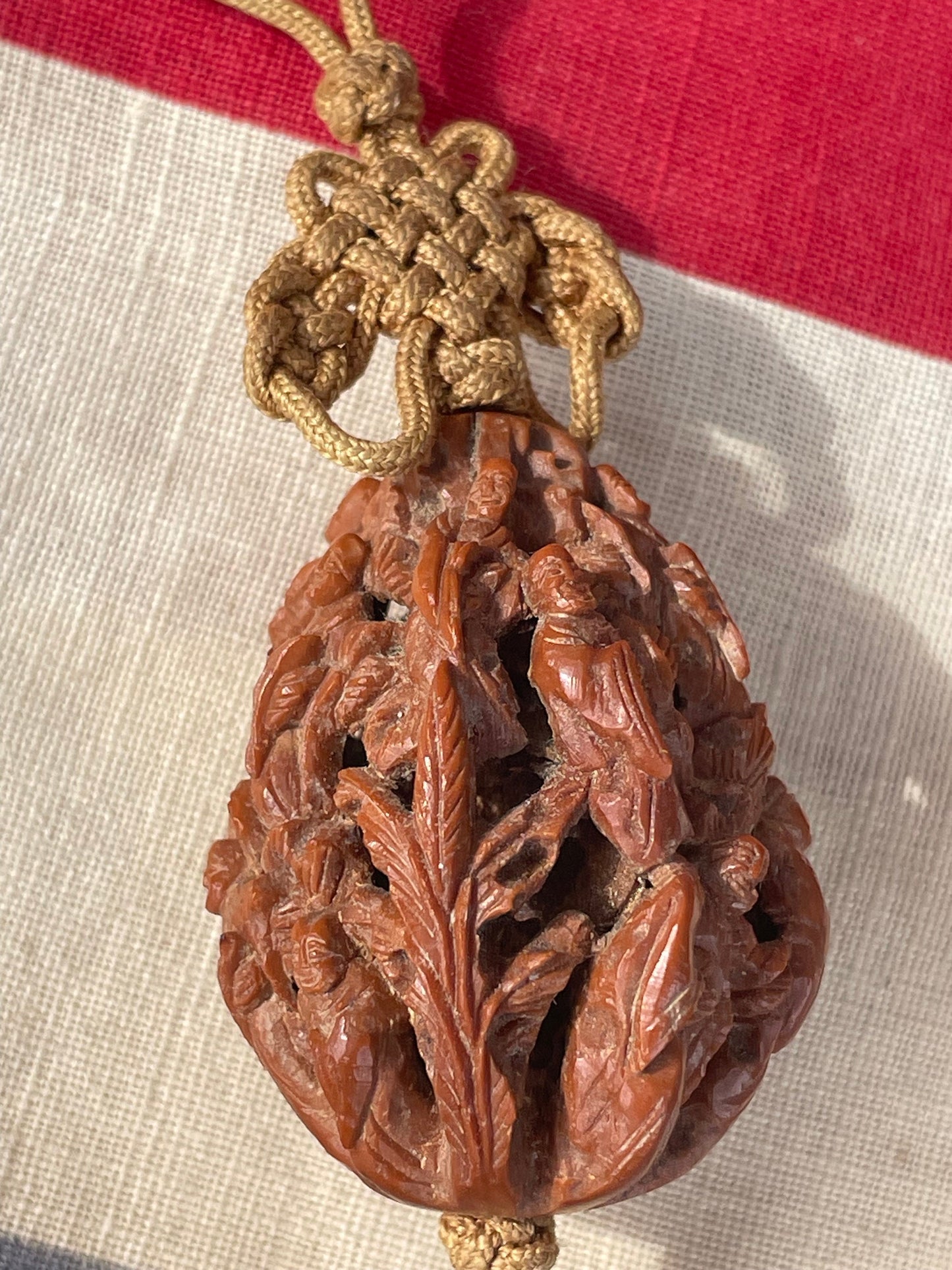 A Hand Carved Chinese Peach Stone Carving on a Silk Cord and Everlasting knot Tassel 42mm Long