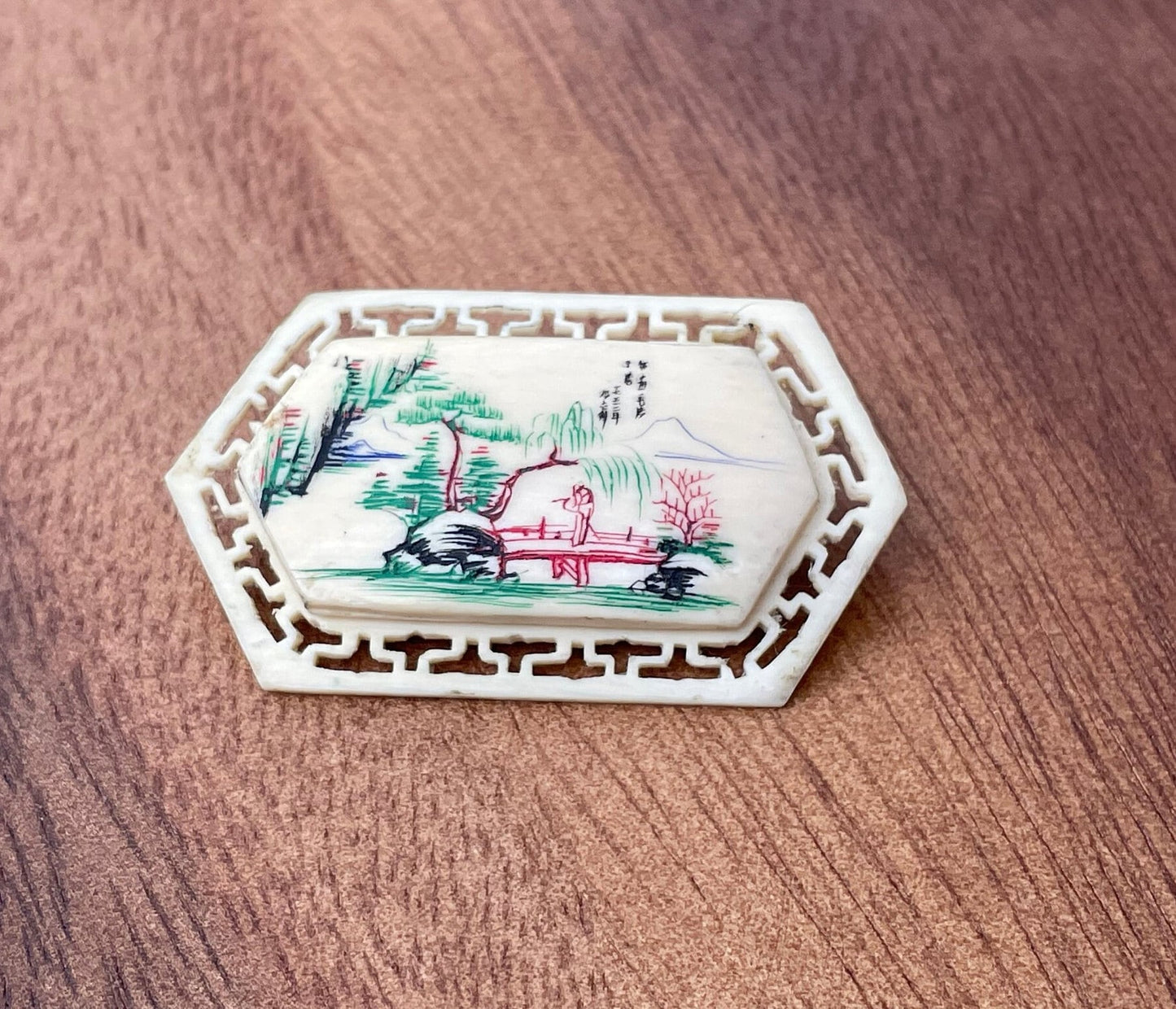 A Small Chinese Brooch With Hand Etched and Coloured Scene 5cm Wide