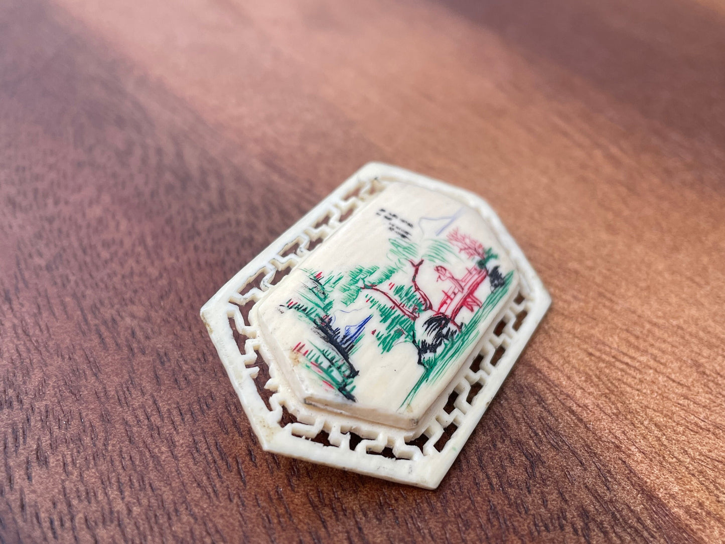 A Small Chinese Brooch With Hand Etched and Coloured Scene 5cm Wide