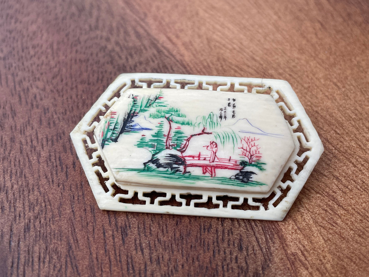 A Small Chinese Brooch With Hand Etched and Coloured Scene 5cm Wide