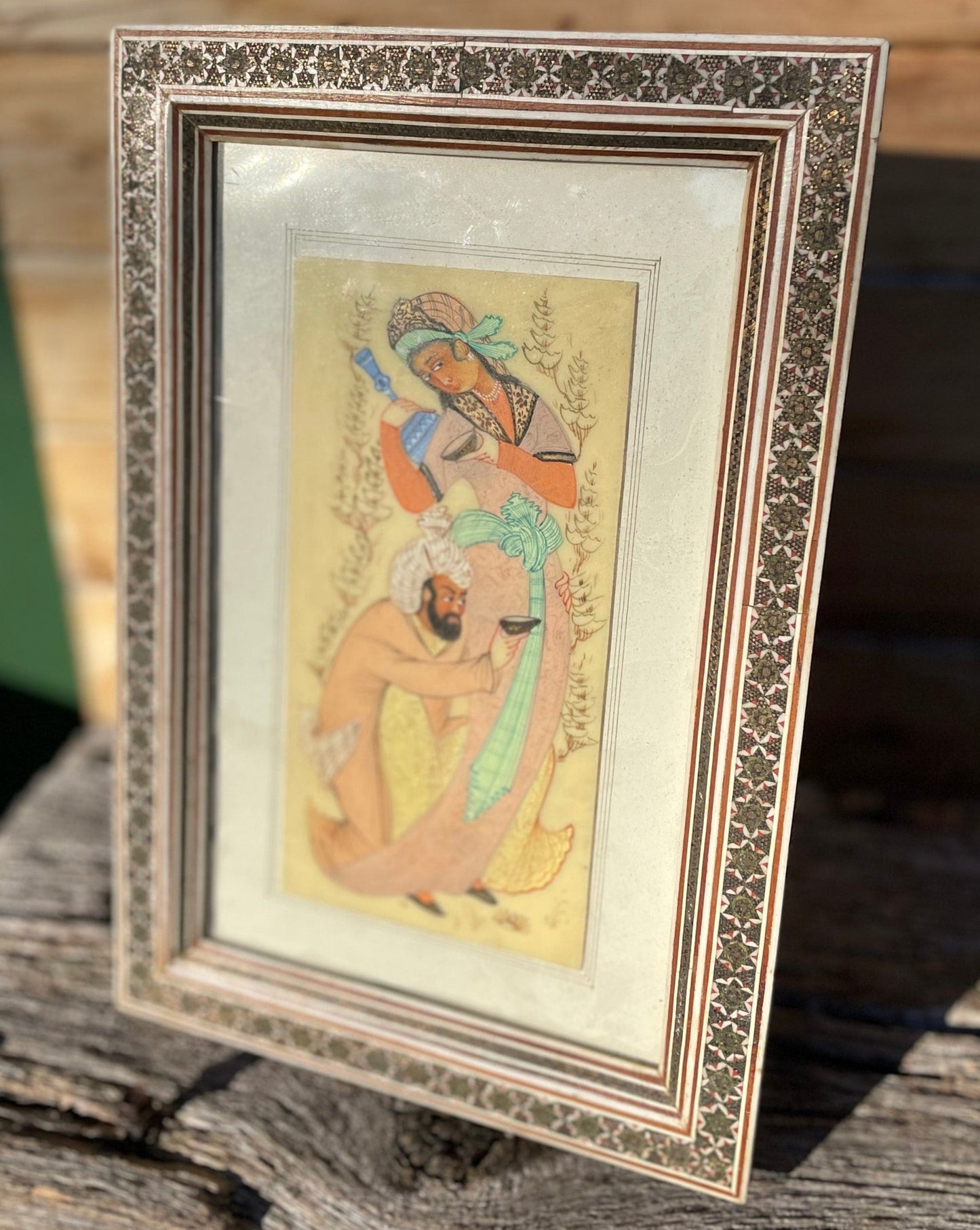 A Persian Hand Painted Panel With two Figures Housed in a Vizagapatam Style Easel Frame 31.5cm Tall