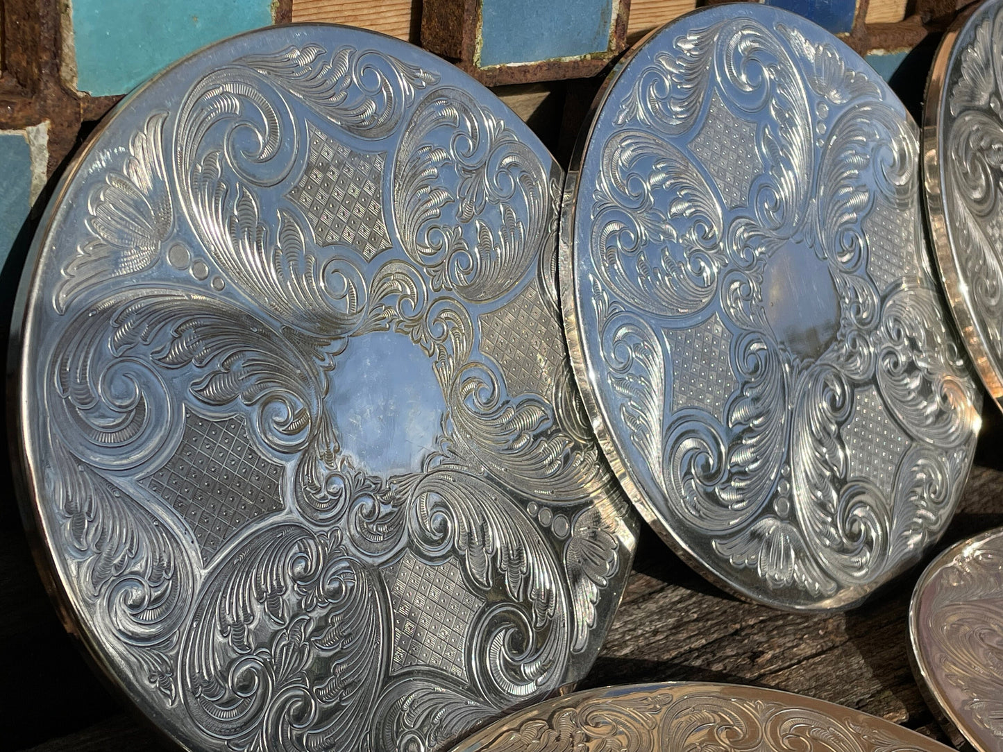 A vintage set of six English silver plated table place mats 16.5cm diameter