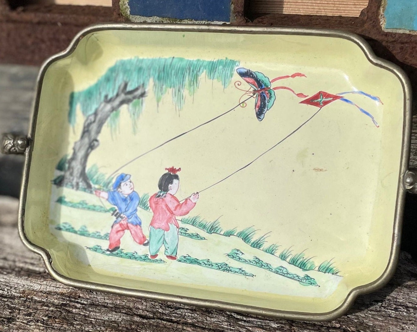 An antique hand painted Chinese enamel decorated pin tray with dragon handles 18cm wide c1900