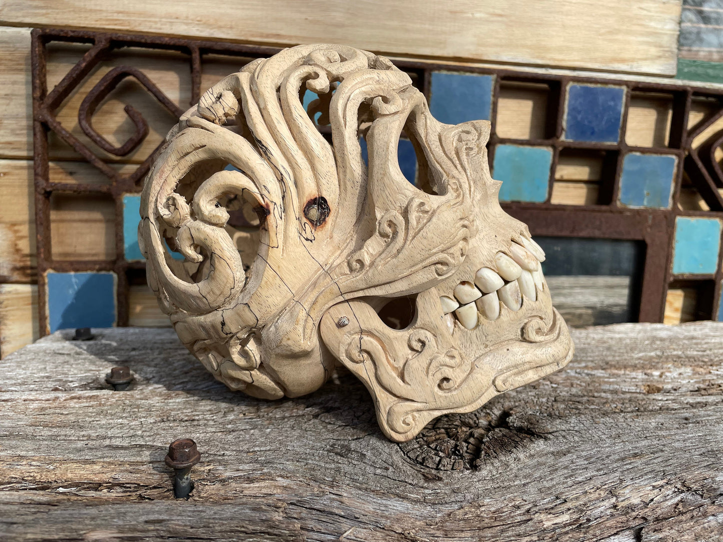 An intricately hand carved Folk Art Skull sculpture from Tamarind wood and buffalo jaw 17cm tall