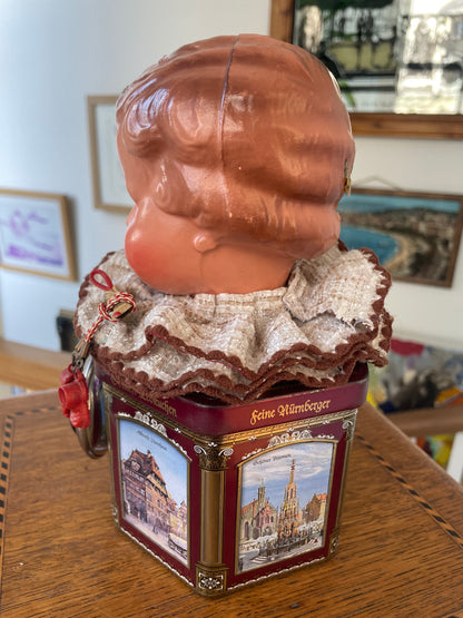 Vintage German “Feine Nürnberger” Tin with Doll Bust Lid & Hidden Miniature Doll –Folk Art Novelty Curio (c.1950s–1970s)