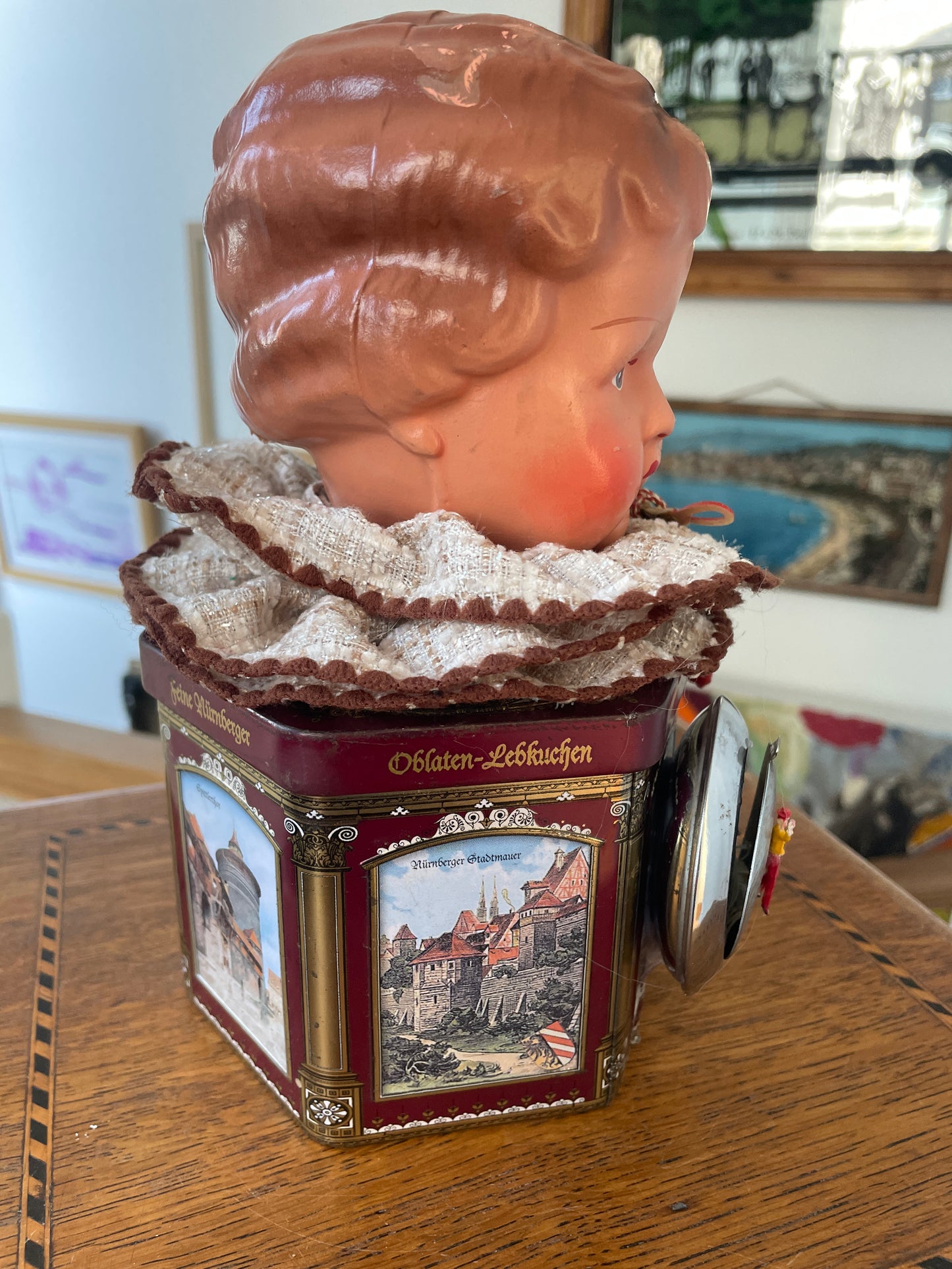 Vintage German “Feine Nürnberger” Tin with Doll Bust Lid & Hidden Miniature Doll –Folk Art Novelty Curio (c.1950s–1970s)