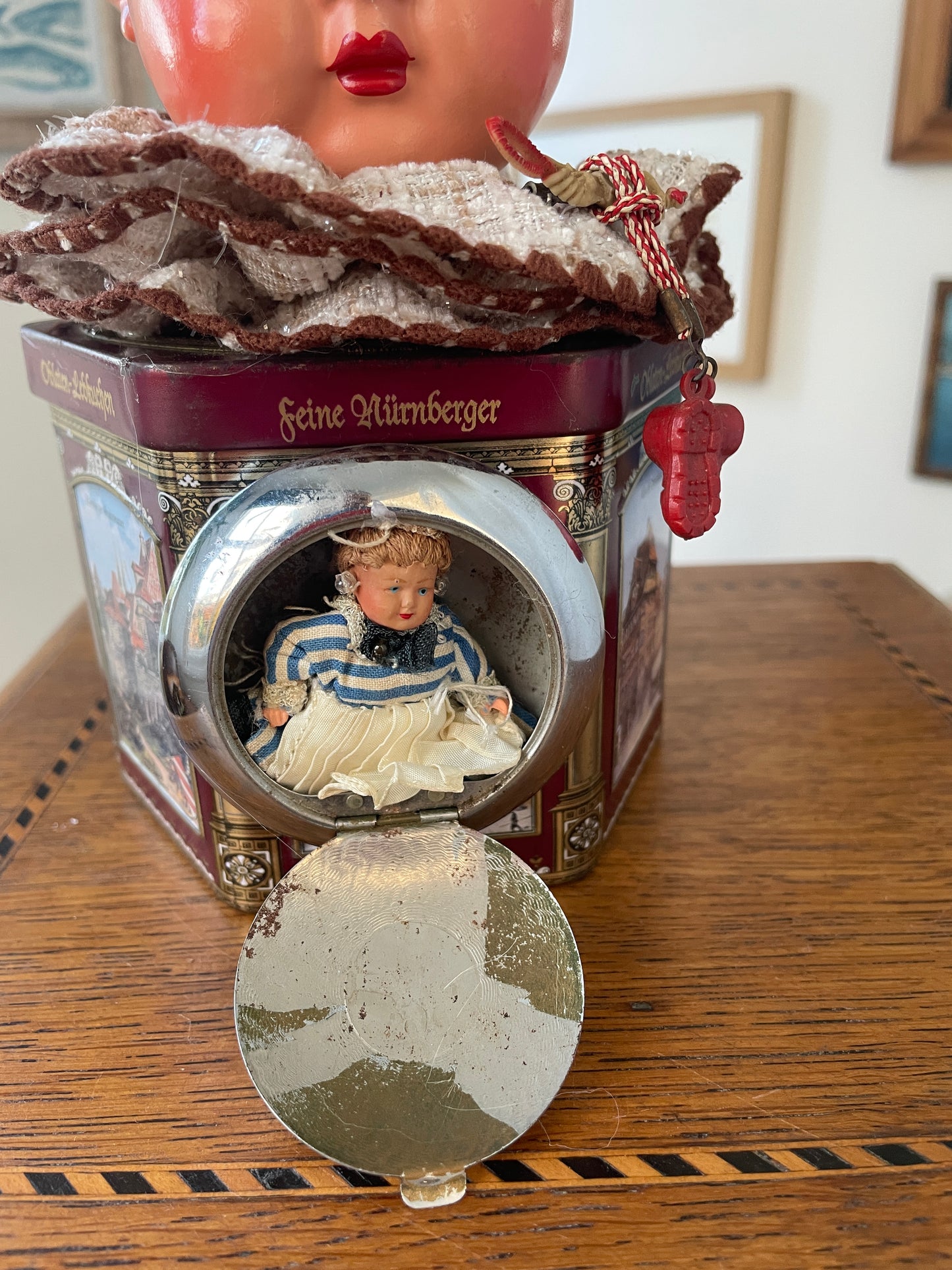 Vintage German “Feine Nürnberger” Tin with Doll Bust Lid & Hidden Miniature Doll –Folk Art Novelty Curio (c.1950s–1970s)