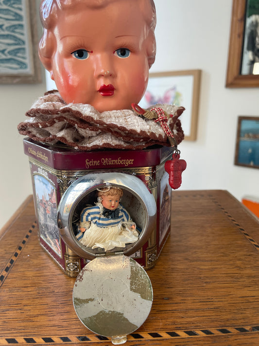 Vintage German “Feine Nürnberger” Tin with Doll Bust Lid & Hidden Miniature Doll –Folk Art Novelty Curio (c.1950s–1970s)