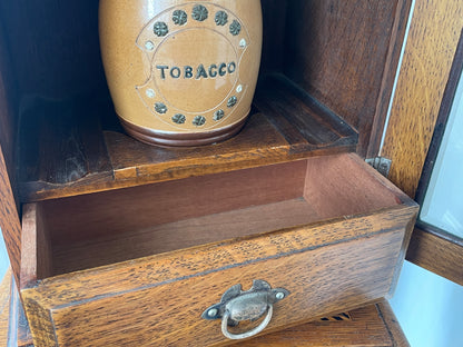 Antique Oak Smokers Cabinet with Bevelled Glass Door and Royal Doulton Lambeth Tobacco Jar (c.1900–1920)
