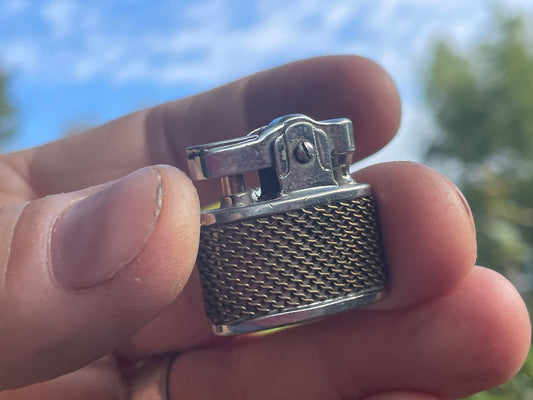 Small petrol lighter called Happy with a chain mail design body 2.5cm wide