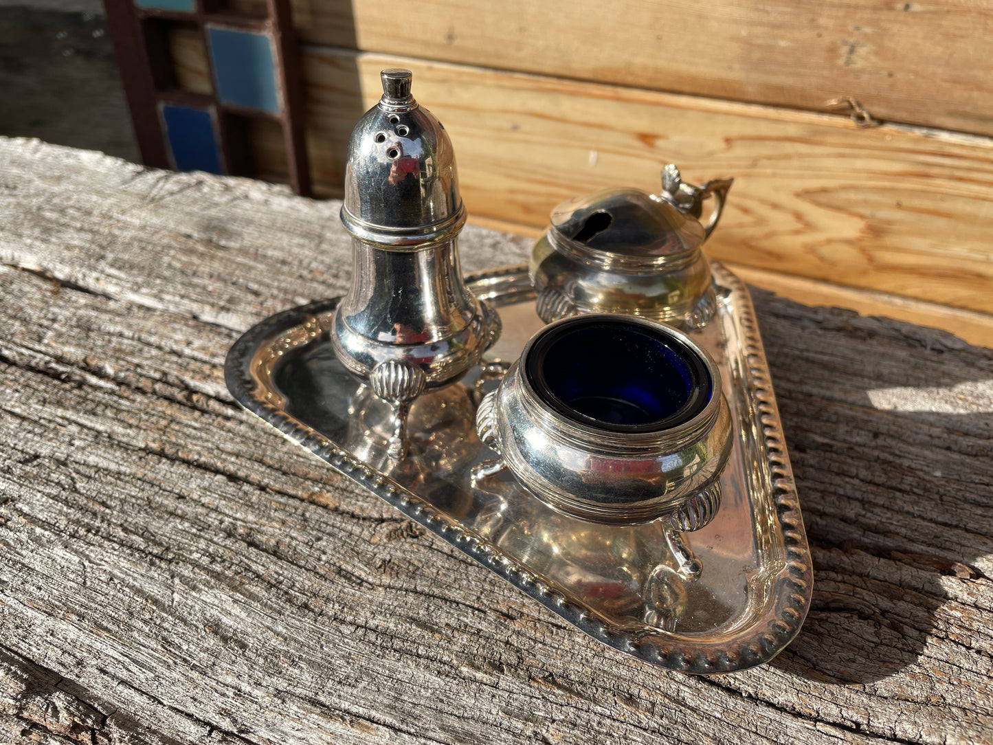 Silver plated cruet set with cobalt blue glass liners and triangular tray