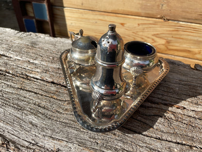 Silver plated cruet set with cobalt blue glass liners and triangular tray