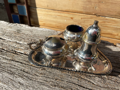 Silver plated cruet set with cobalt blue glass liners and triangular tray