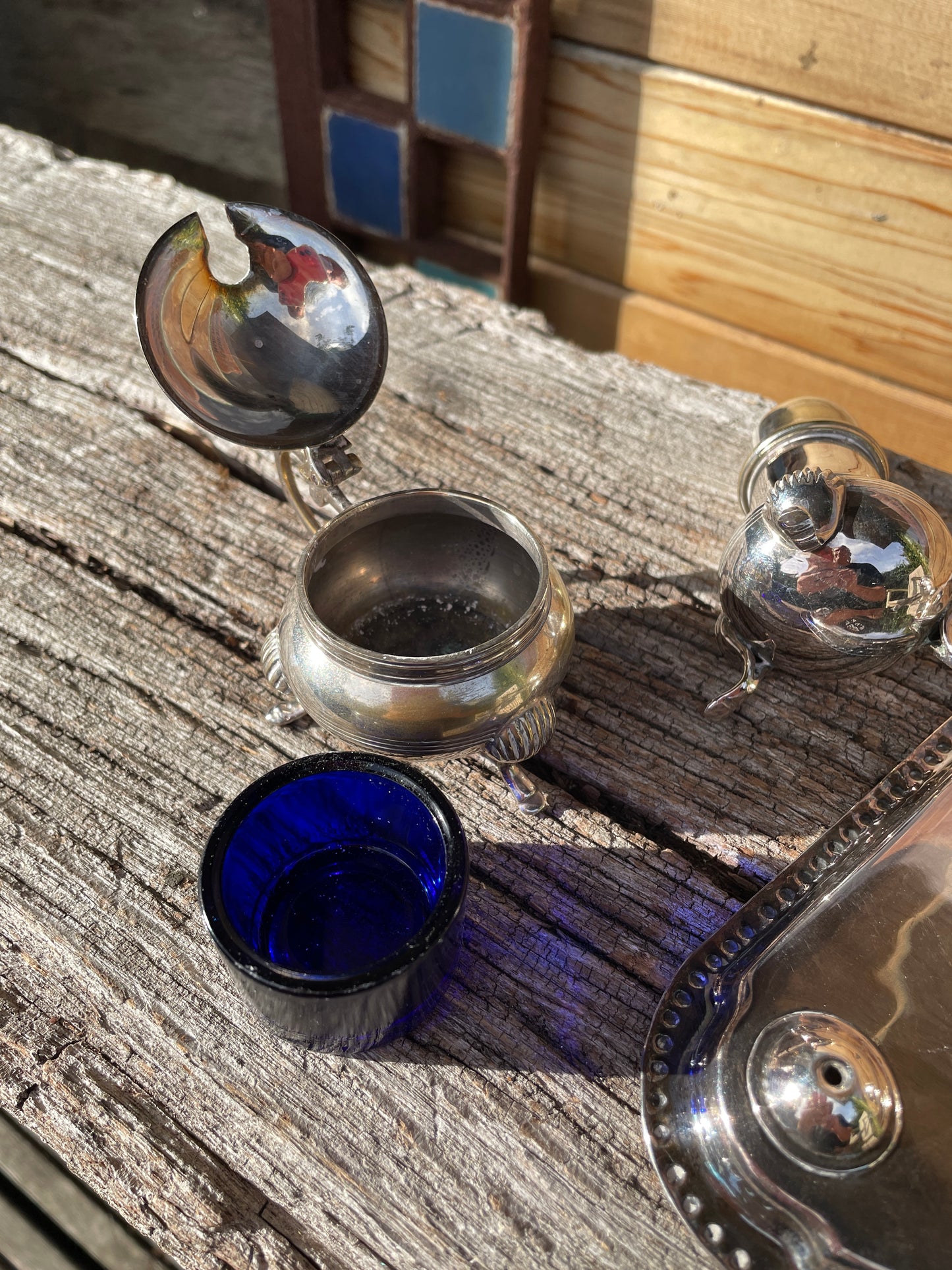 Silver plated cruet set with cobalt blue glass liners and triangular tray