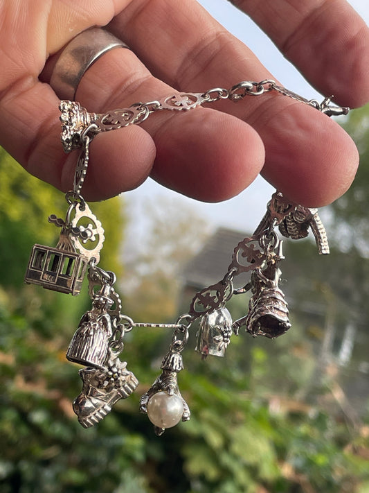 Charm bracelet some marked 800 silver 26g