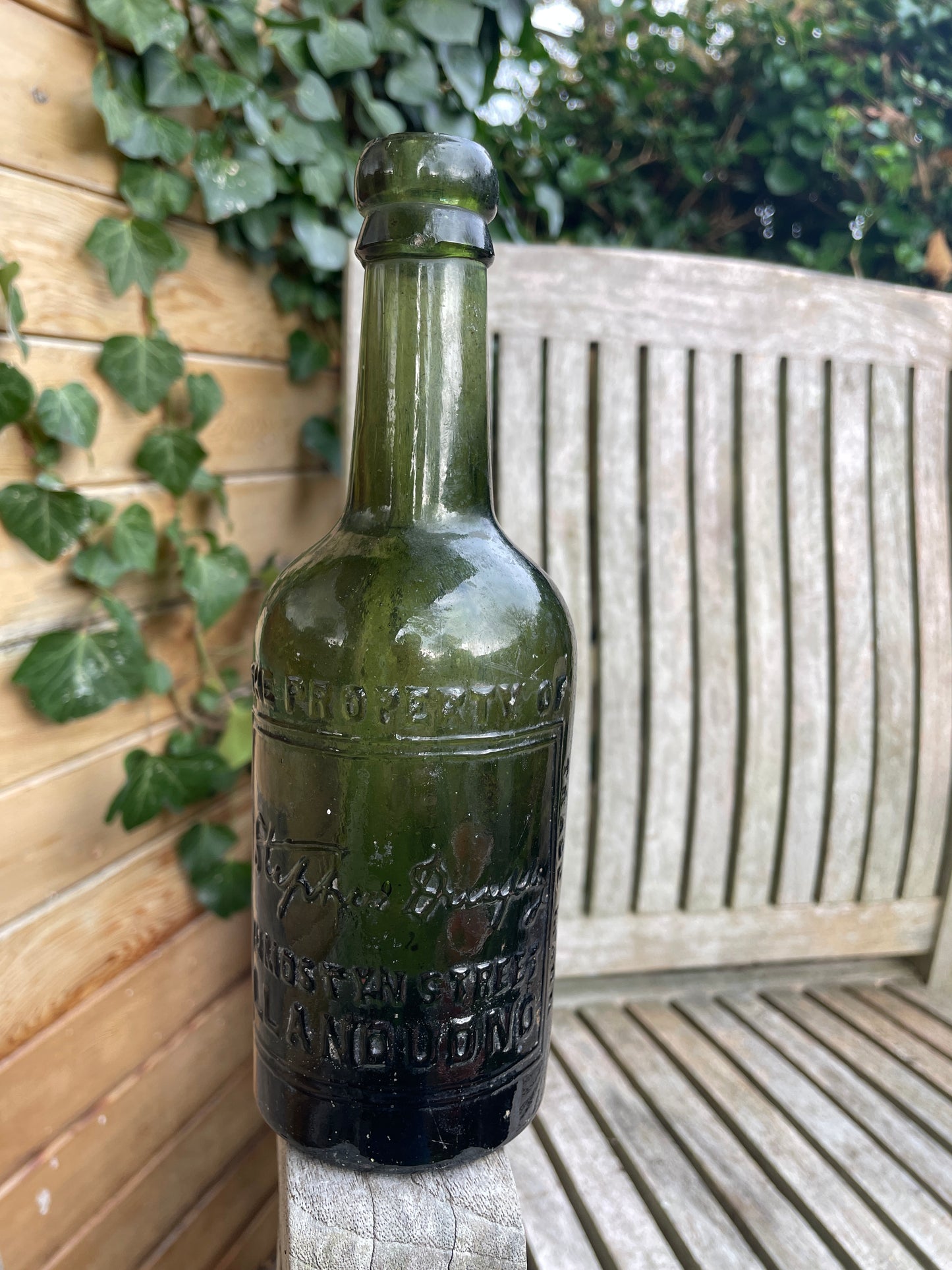 Antique green glass bottle Stephen Dunphy 111 Mostyn Street Llandudno North Wales c1900