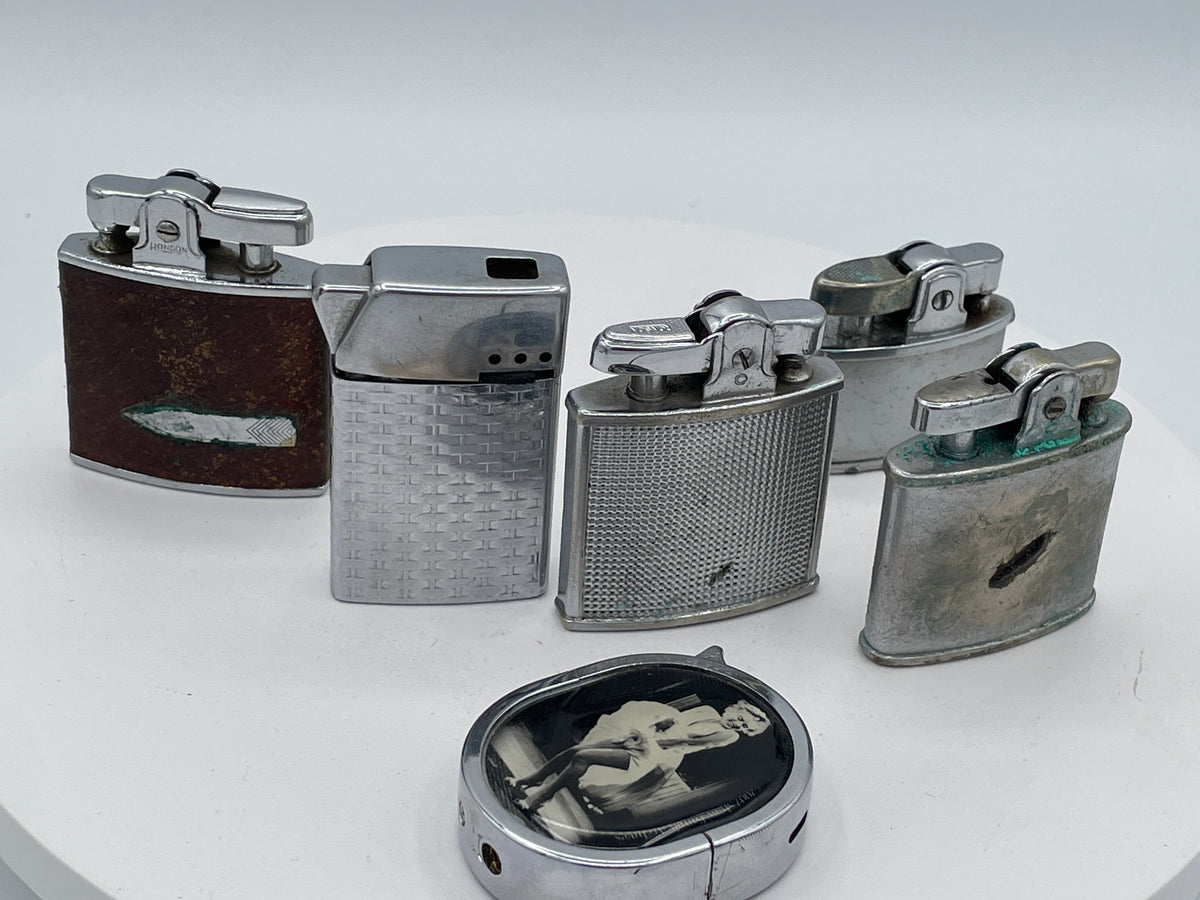 Vintage Sextet of Collectible Pocket Lighters: Ronson, Sim, and Marilyn Monroe Champ – Mid-20th Century & Modern