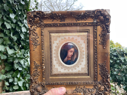 Antique watercolour miniature on ceramic cushion frame surround mounted in a giltwood and gesso decorated frame