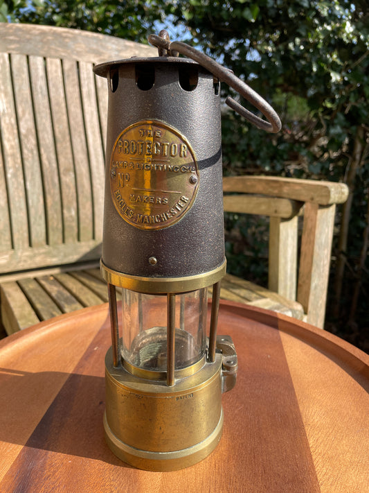 Antique brass miners lamp called The Protector lamp and lighting Co of Eccles Manchester