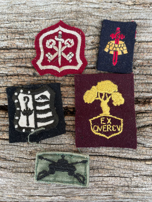Collection of fabric military patches and badges including US and British examples