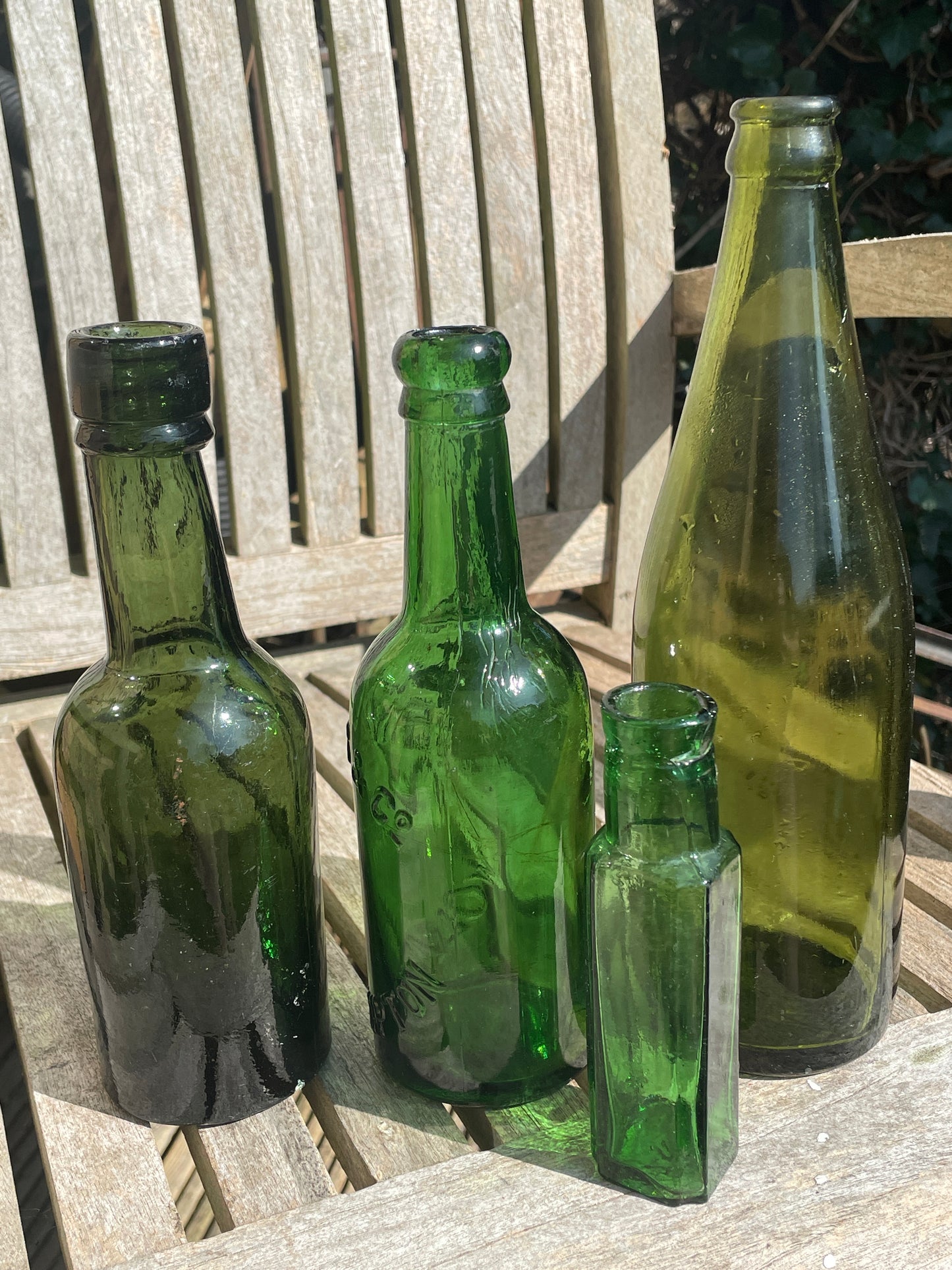 Four antique and vintage green glass bottles