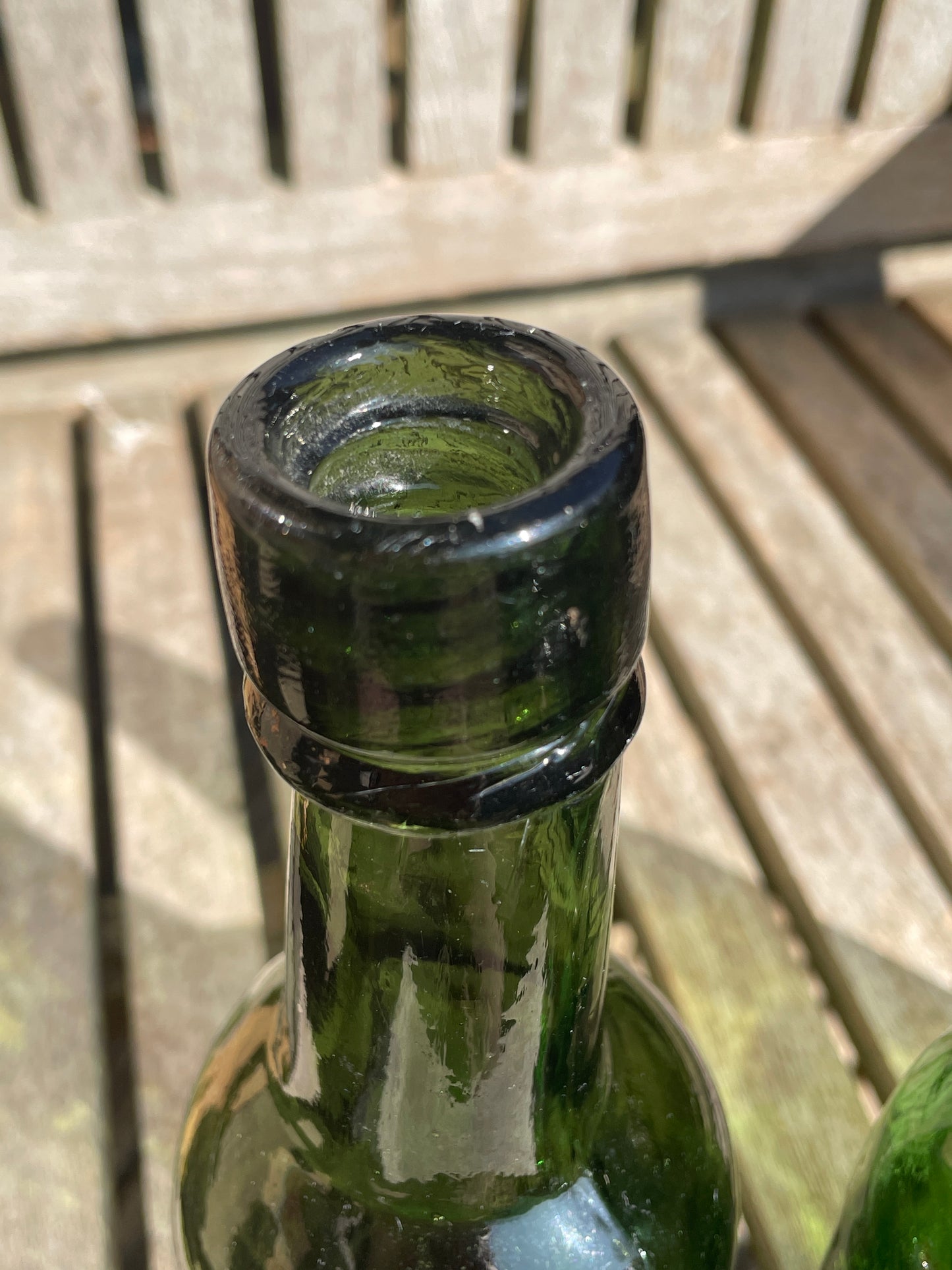 Four antique and vintage green glass bottles