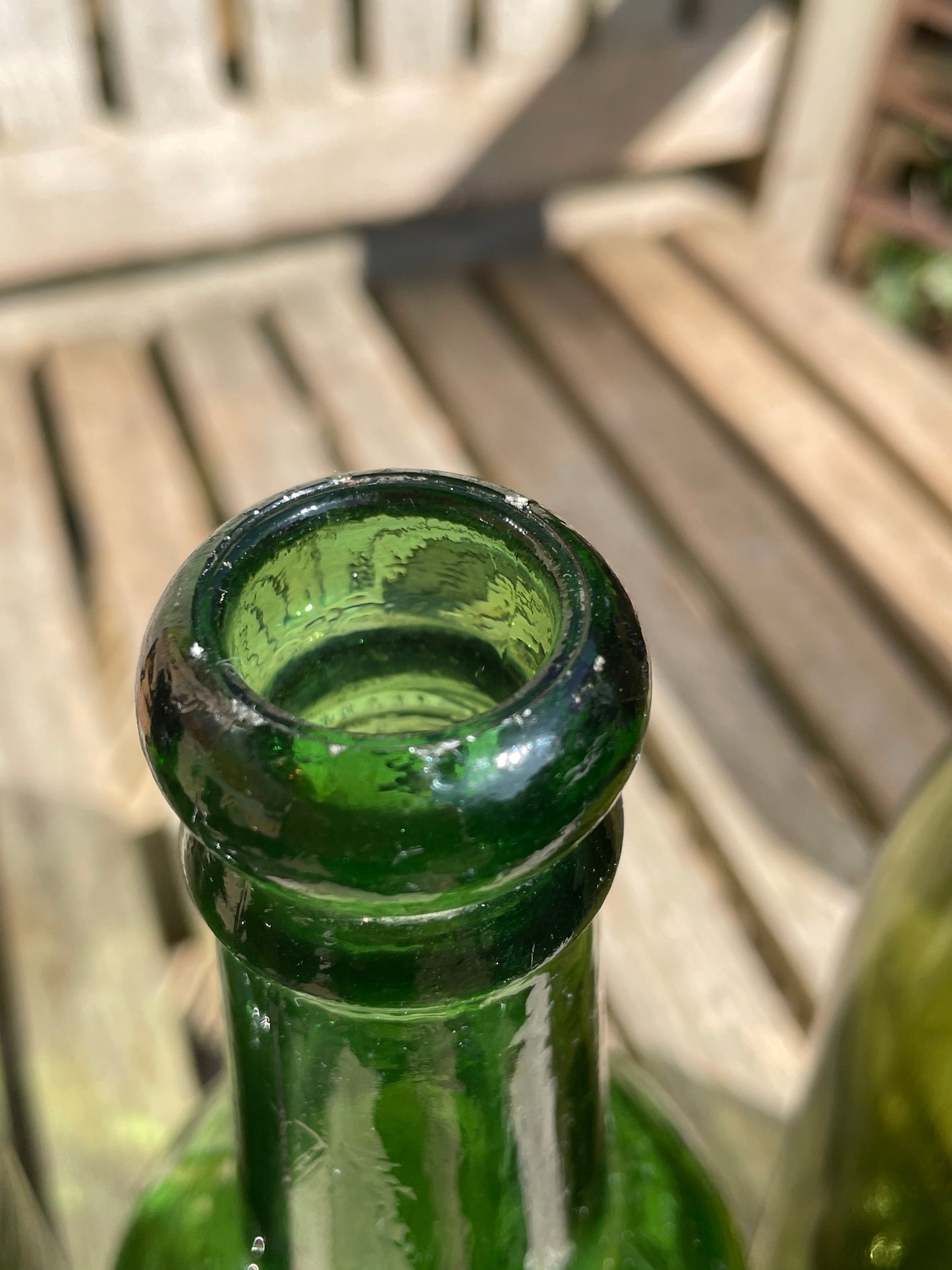Four antique and vintage green glass bottles