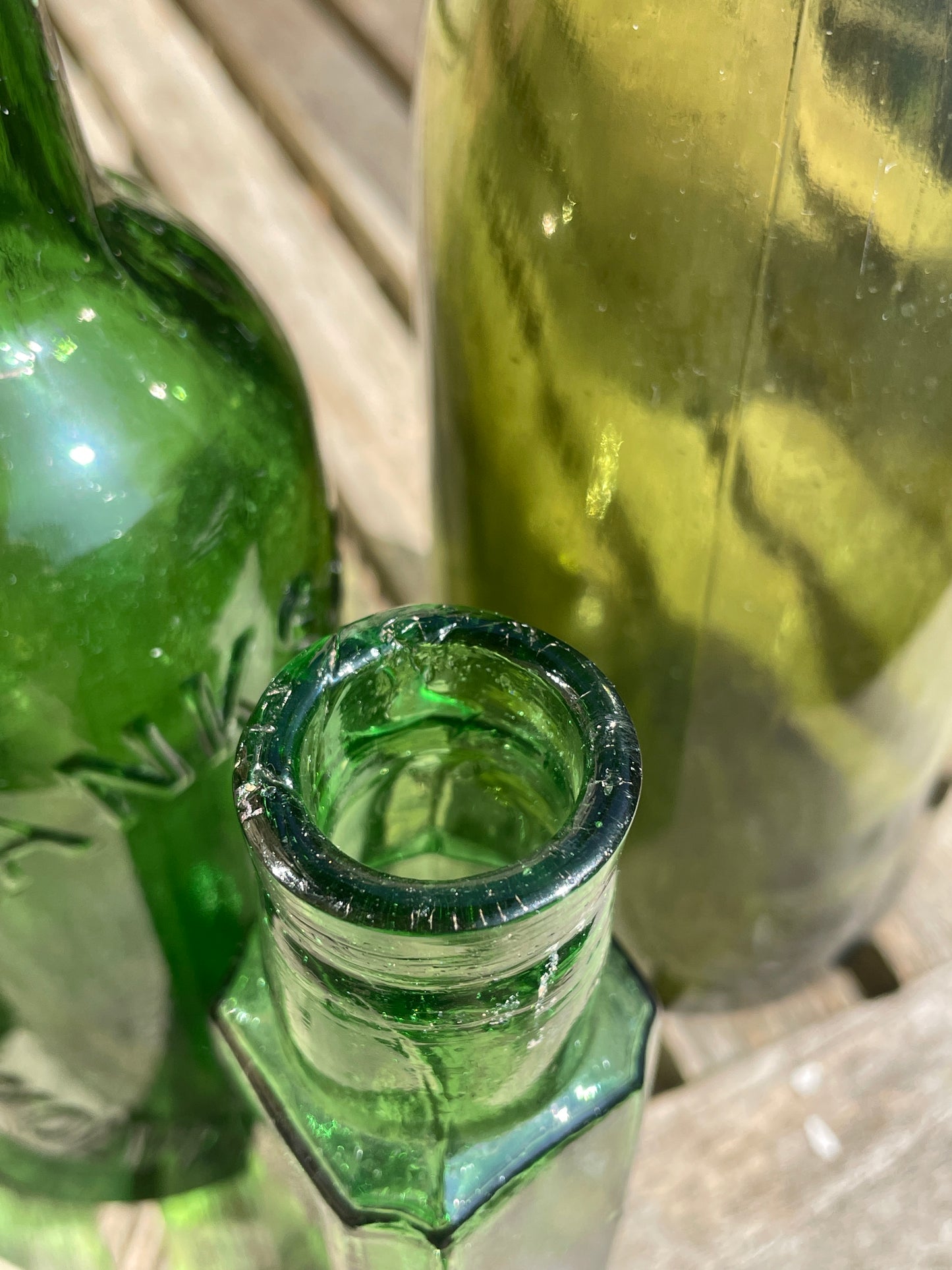 Four antique and vintage green glass bottles