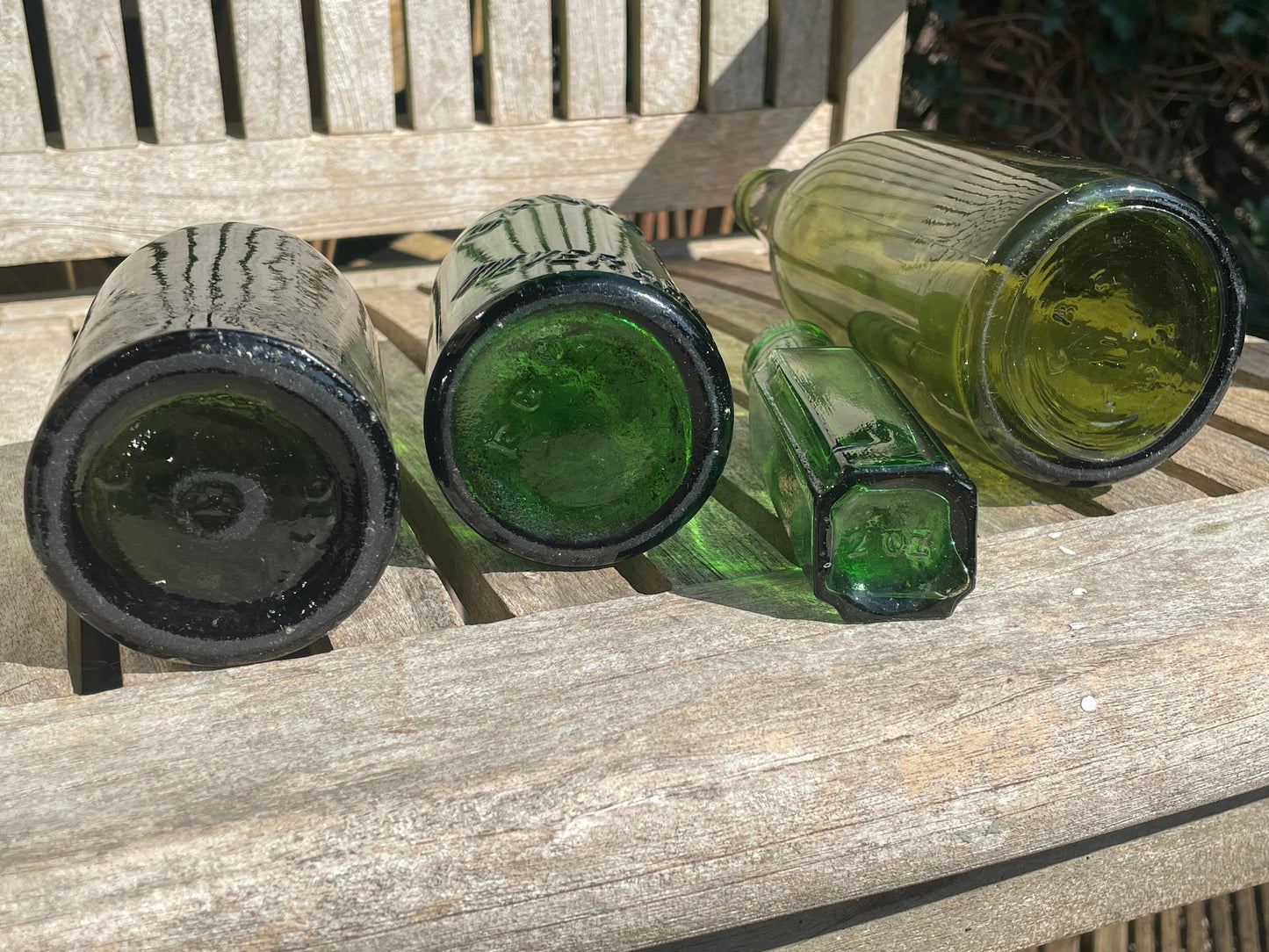 Four antique and vintage green glass bottles