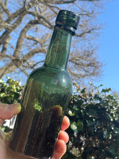 Four antique and vintage green glass bottles