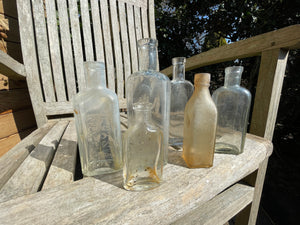 six antique and vintage clear glass bottles tallest  - Sloan's Liniment example 15cm