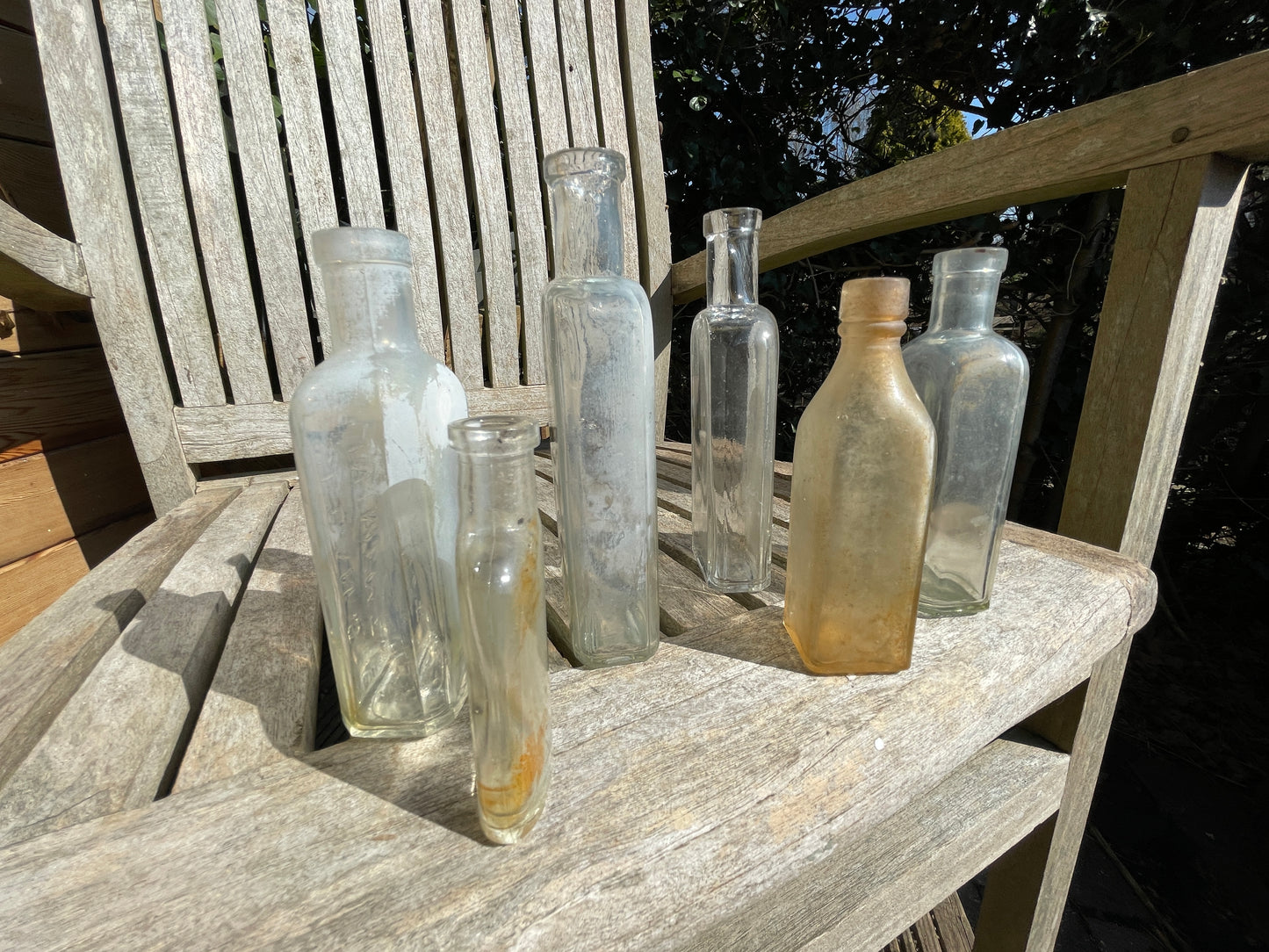 six antique and vintage clear glass bottles tallest  - Sloan's Liniment example 15cm