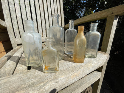six antique and vintage clear glass bottles tallest  - Sloan's Liniment example 15cm