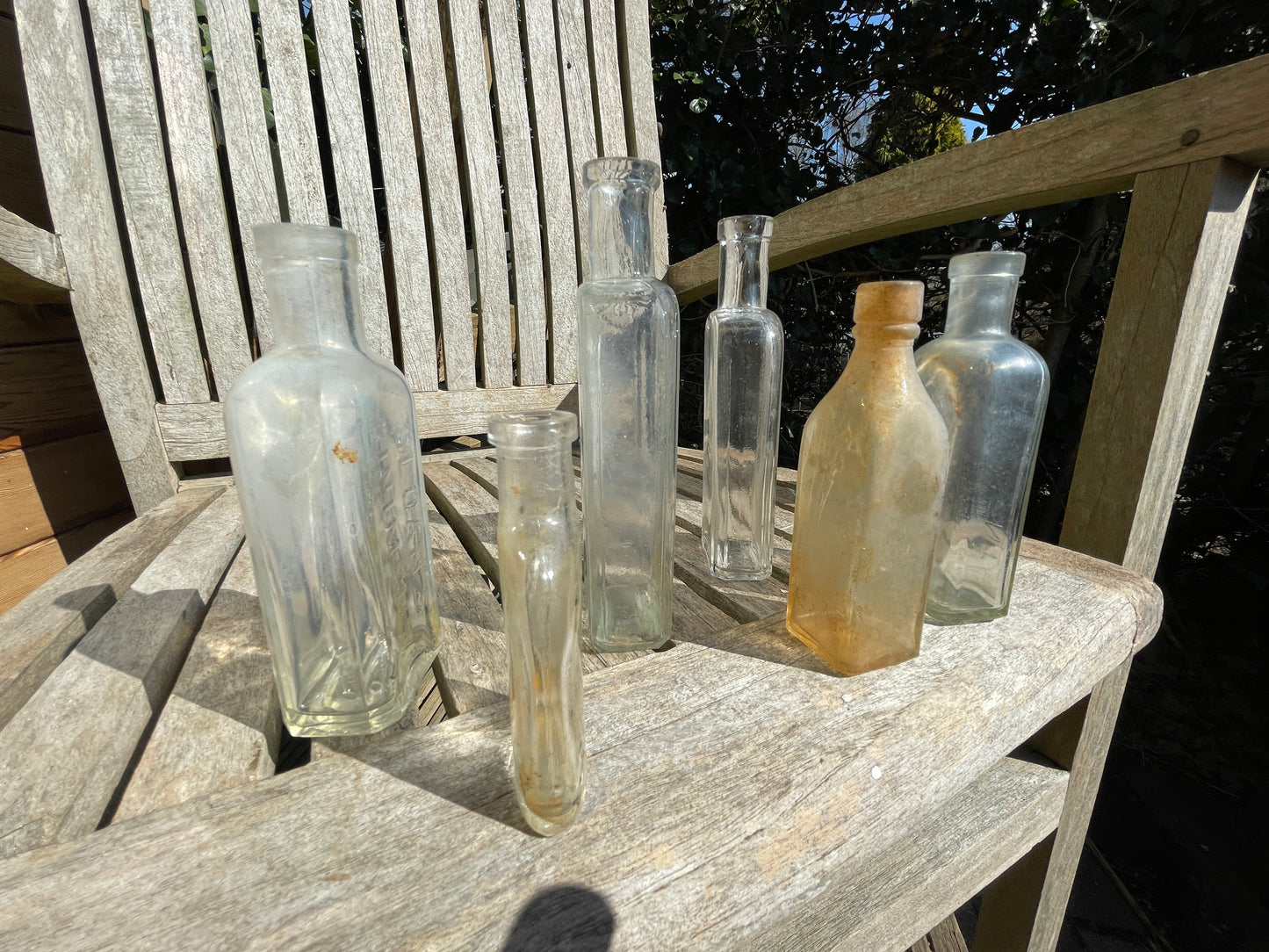six antique and vintage clear glass bottles tallest  - Sloan's Liniment example 15cm