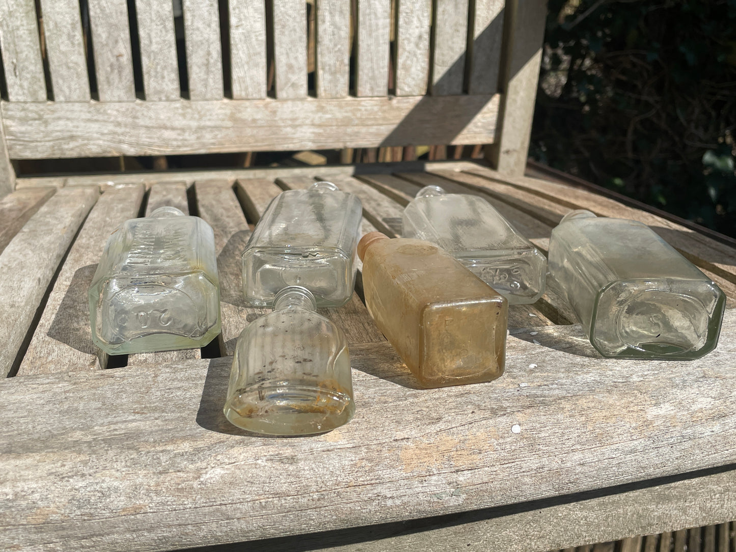 six antique and vintage clear glass bottles tallest  - Sloan's Liniment example 15cm