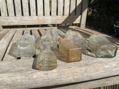 six antique and vintage clear glass bottles tallest  - Sloan's Liniment example 15cm