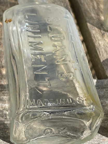 six antique and vintage clear glass bottles tallest  - Sloan's Liniment example 15cm