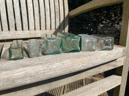 Six antique and vintage clear glass square section bottles tallest 21.5cm