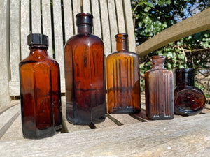 Five Antique and vintage brown glass bottles incl. Milton 4 and 5 and two ribbed Examples