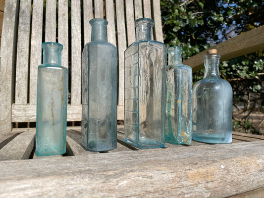 five Victorian pale blue antique Victorian bottles - Two ribbed examples tallest 16.5cm