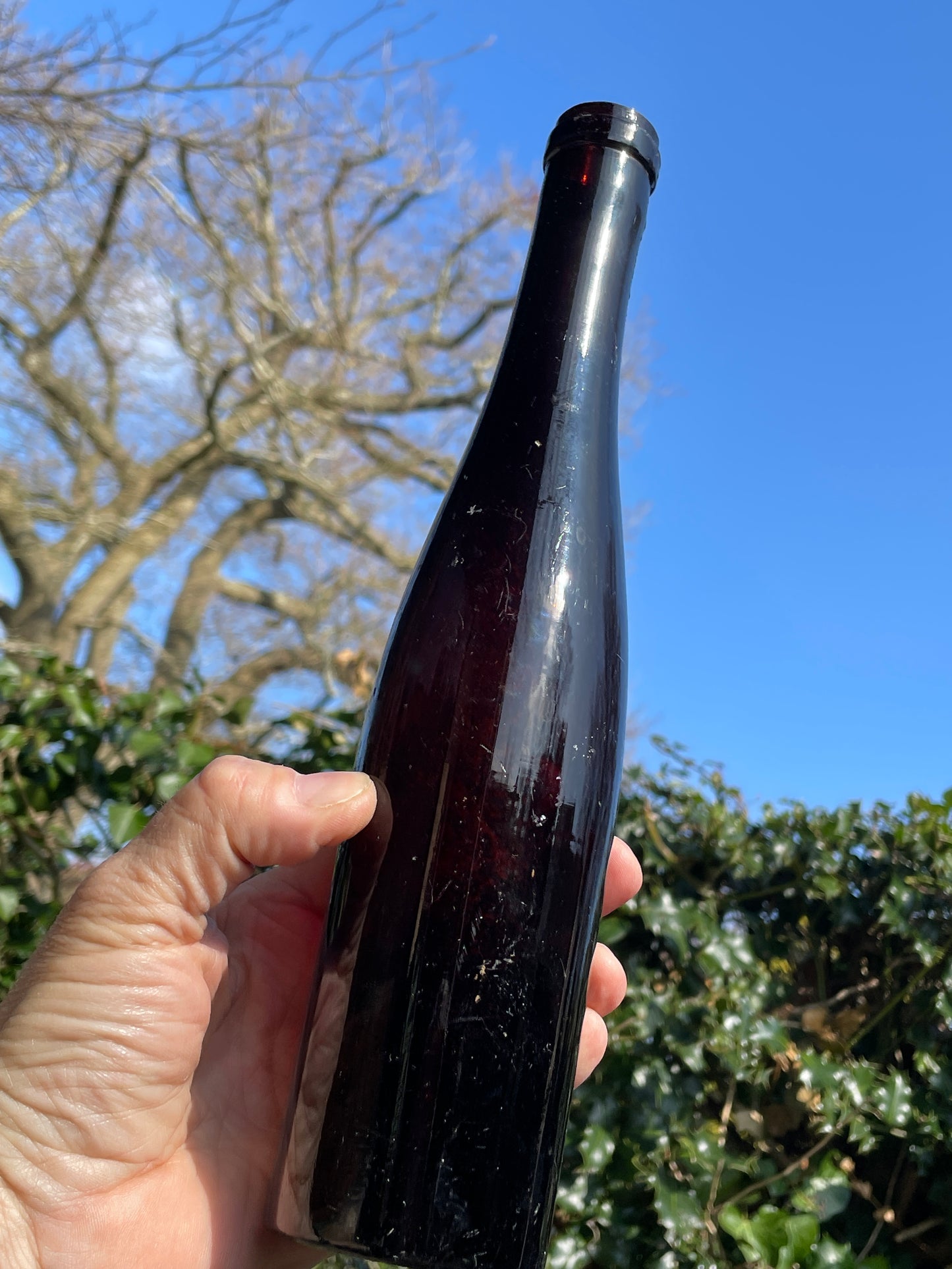 Three Vintage brown glass bottles tallest 29cm
