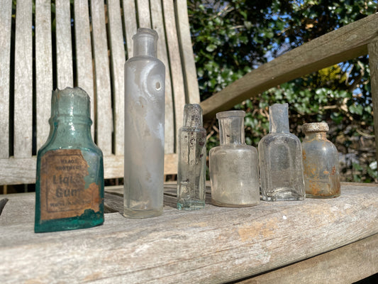 six  19th century glass bottles including Liquid gum Wolverhampton Reade Brothers and American examples