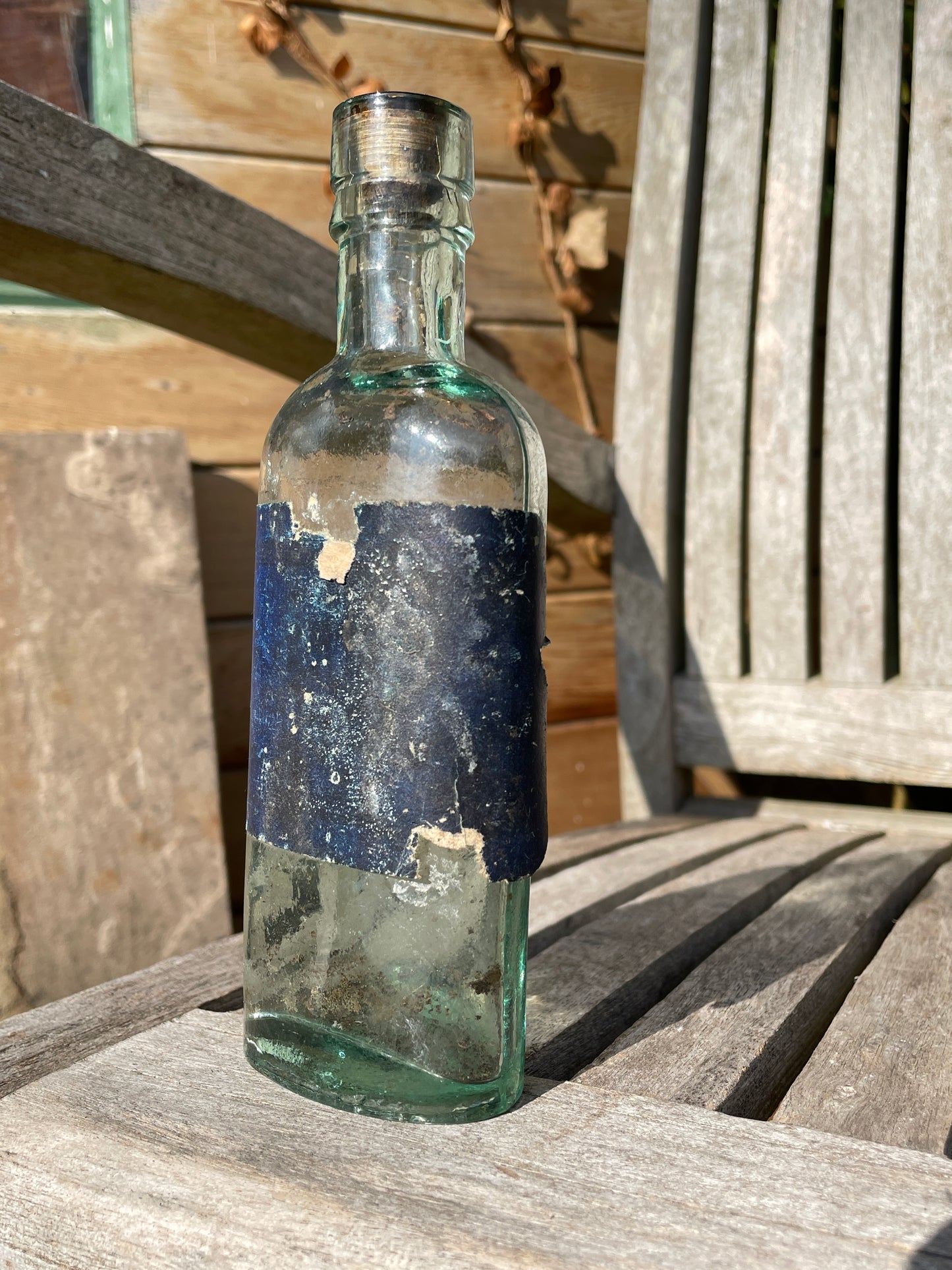 Victorian bottle with original label and cork embossed S&R to base
