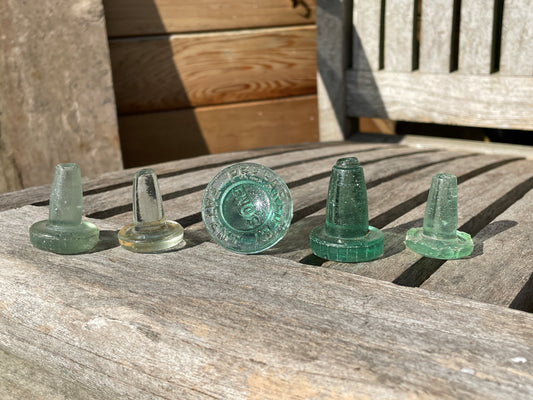 Five glass bottle stoppers one marked Prepared by Eno's Patent c1890's