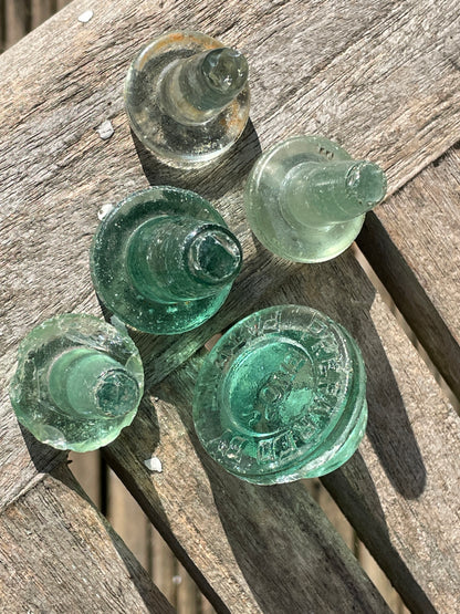 Five glass bottle stoppers one marked Prepared by Eno's Patent c1890's