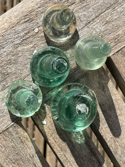Five glass bottle stoppers one marked Prepared by Eno's Patent c1890's
