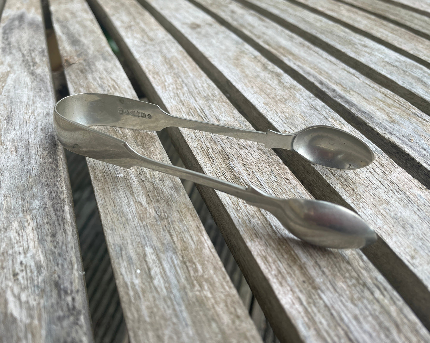 A  pair of silver plate sugar tongs by Pinder Bros 11.5cm long