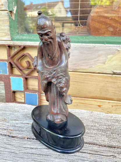 A Chinese Root Wood Hand Carving of an Elder Raised on a Later Oval Ebony Base, Overall 23.5cm High