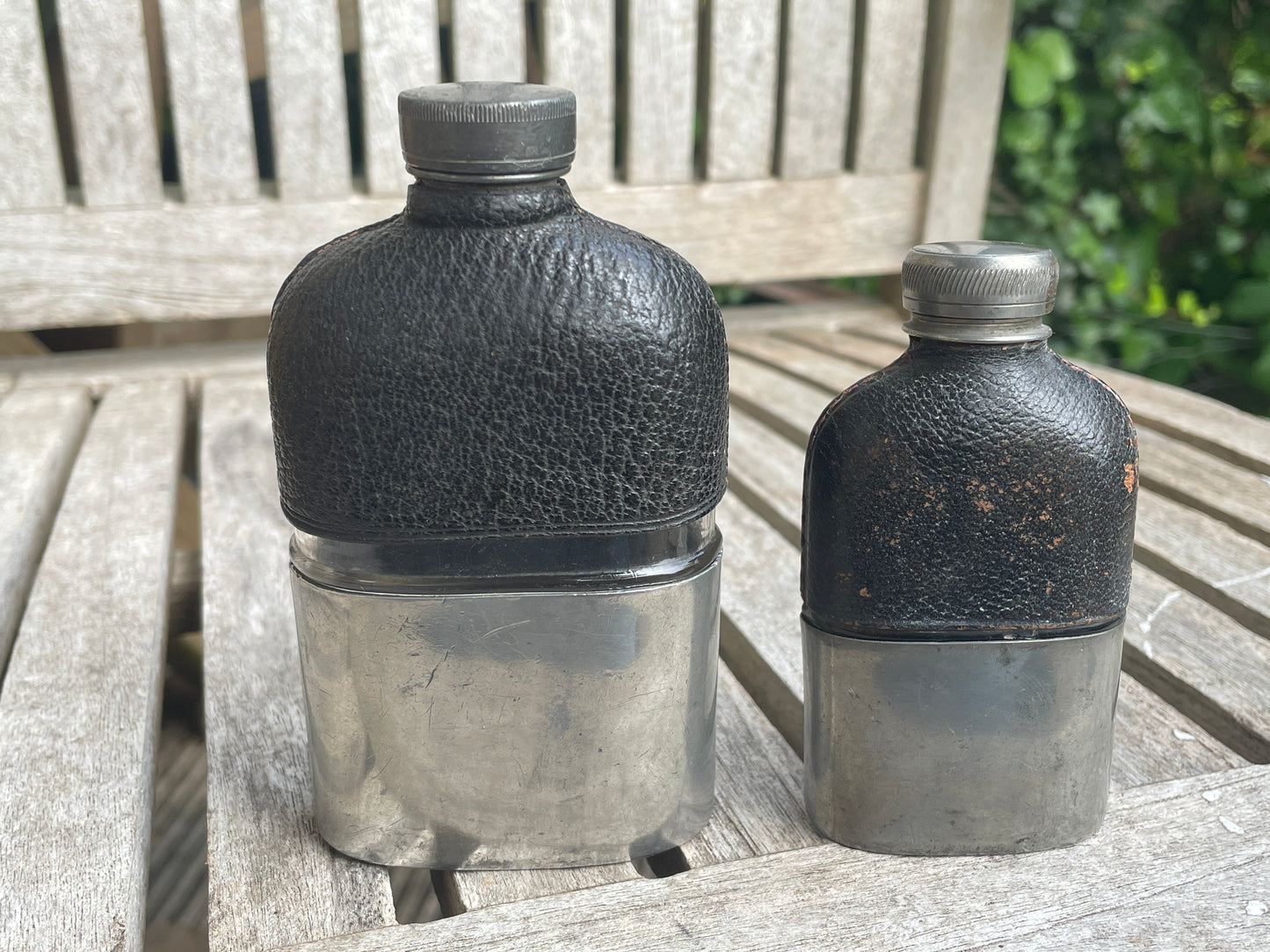 Pair of Vintage Leather & Metal Hip Flasks – Travel Companion Bottles with Removable Cups, Early to Mid 20th Century